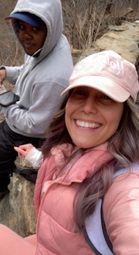 two people taking a selfie on a rock