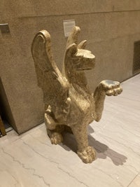 a statue of a griffin on a marble floor