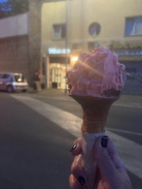 a person holding an ice cream cone